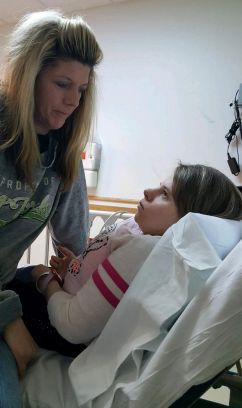 The author keeps her daughter Emily company in the hospital. "Witnessing Emily wince in pain, convulse or withdraw from her social life, I don’t always know the words to say or how to help her," she writes.