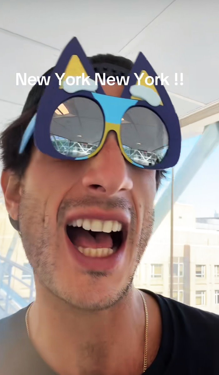 A man takes a video of himself singing a song wearing wacky sunglasses