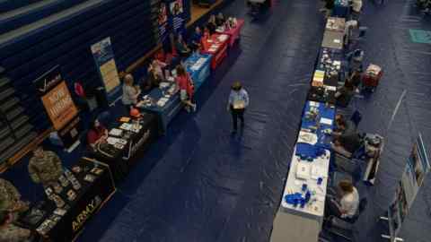 People browse stalls at a career fair