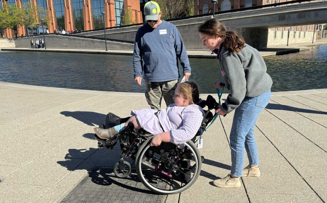 Occupational therapist and Skills on Wheels volunteer Maria Fuchs guides 12-year-old Savannah Healton through some wheelchair skills.