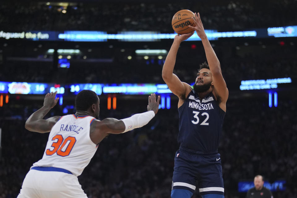 NEW YORK, NEW YORK - JANUARY 1: Karl-Anthony Towns #32 of the Minnesota Timberwolves shoots the ball against Julius Randle #30 of the New York Knicks at Madison Square Garden on January 1, 2024 in New York City. The Knicks defeated the Timberwolves 112-106. NOTE TO USER: User expressly acknowledges and agrees that, by downloading and or using this photograph, User is consenting to the terms and conditions of the Getty Images License Agreement. (Photo by Mitchell Leff/Getty Images)