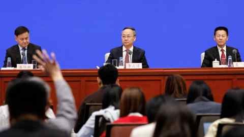 People’s Bank of China Governor Pan Gongsheng, National Financial Regulatory Administration Minister Li Yunze and China Securities Regulatory Commission chairman Wu Qing at a press conference in Beijing