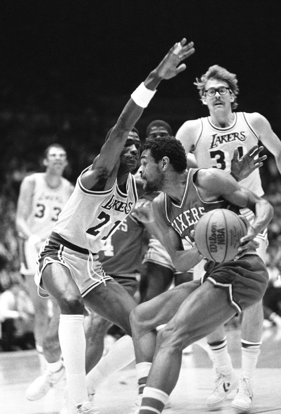 Lakers forward Michael Cooper tries to cut off a drive by 76ers guard Maurice Cheeks during a game in the 1983 NBA Finals.