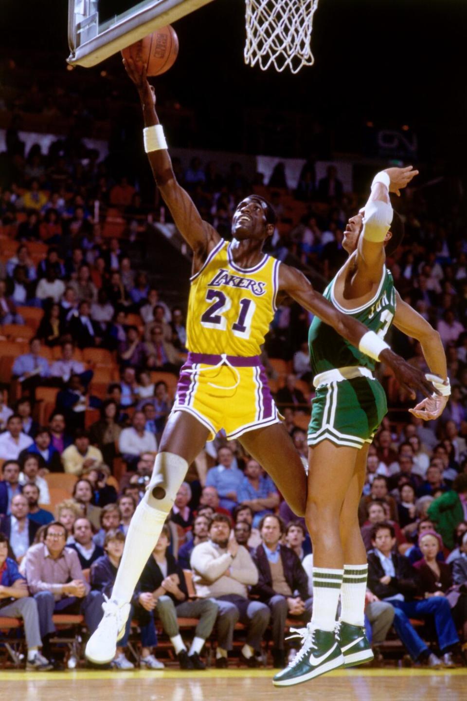 Lakers forward Michael Cooper glides past Celtics guard Dennis Johnson for layup during a game in the 1985 NBA Finals.