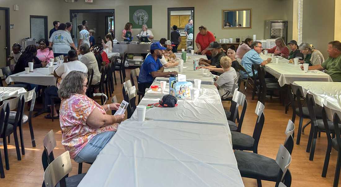 Families eat dinner at Locust Grove Baptist Church in New Market, Alabama on August 22, at a meeting about a new pilot program that gives some opioid settlement money directly to grandparents raising their grandchildren.