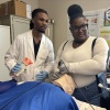 Jerrian Reedy (left), a student at the University of Mississippi School of Medicine, assists Dorothy Gray, a student at Northside High School in the Mississippi Delta, as she practices intubation in a simulation lab. Gray, who is interested in pursuing a career in the mental health care field, attended the University of Mississippi School of Medicine’s annual African American Visit Day in April.