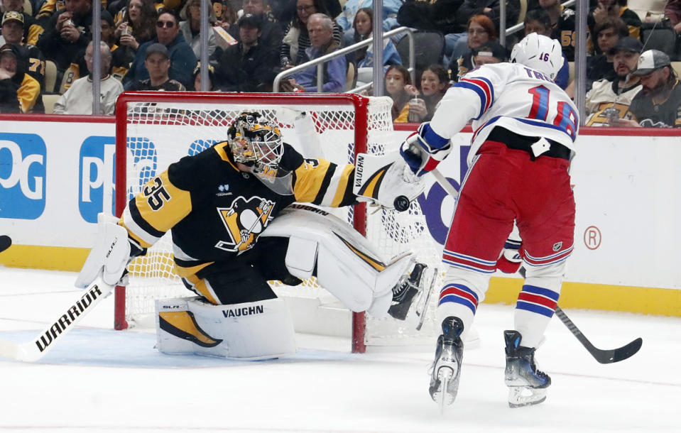 Oct 9, 2024; Pittsburgh, Pennsylvania, USA; Pittsburgh Penguins goaltender Tristan Jarry (35) makes a glove save against New York Rangers center Vincent Trocheck (16) during the third period at PPG Paints Arena. Mandatory Credit: Charles LeClaire-Imagn Images