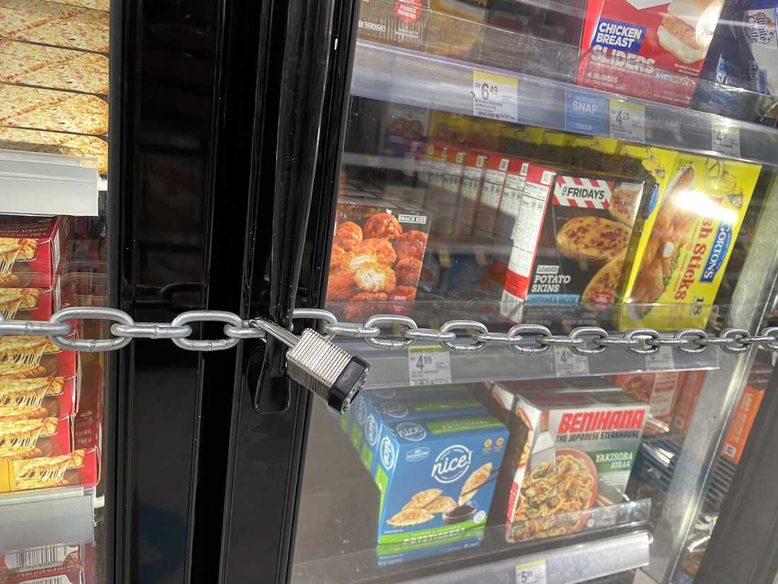 A chain with padlocks secures freezer doors at a San Francisco Walgreens store in July 2023. The store locked its freezers with chains and padlocks to thwart shoplifters that had been stealing frozen pizzas and ice cream.