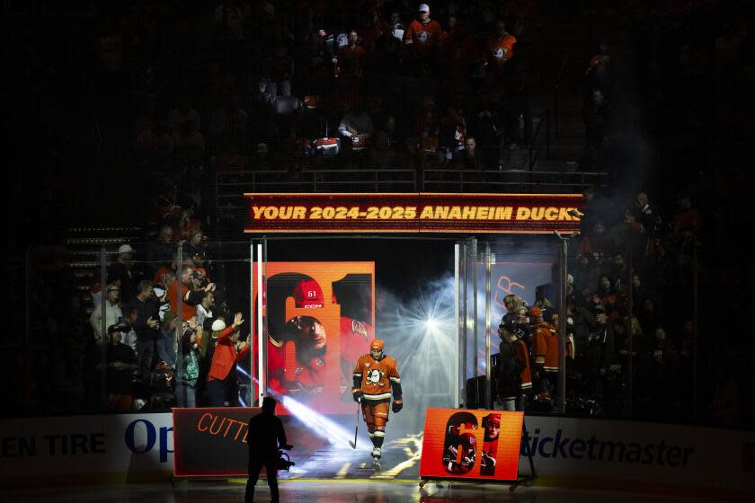 Anaheim Ducks left wing Cutter Gauthier (61) enters the rink before an NHL hockey game against the Utah Hockey Club, Wednesday, Oct. 16, 2024, in Anaheim, Calif. (AP Photo/Kyusung Gong)