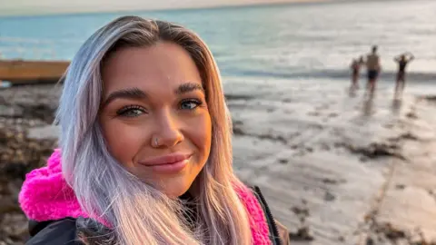 Jessie Hallett Selfie of girl on beach smiling 