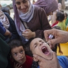 A health worker administers an oral polio vaccine in Zawayda, in the central Gaza Strip.