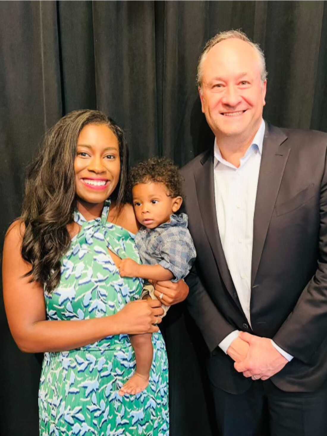 Kaitlyn Joshua and her son, Liam, pose with Second Gentleman Doug Emhoff during a rally for then-candidate President Joe Biden in Clawson, Michigan on June 24, 2024.