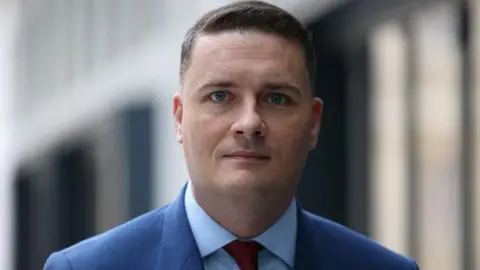 Reuters Wes Streeting standing in front of a building, looking directly into camera