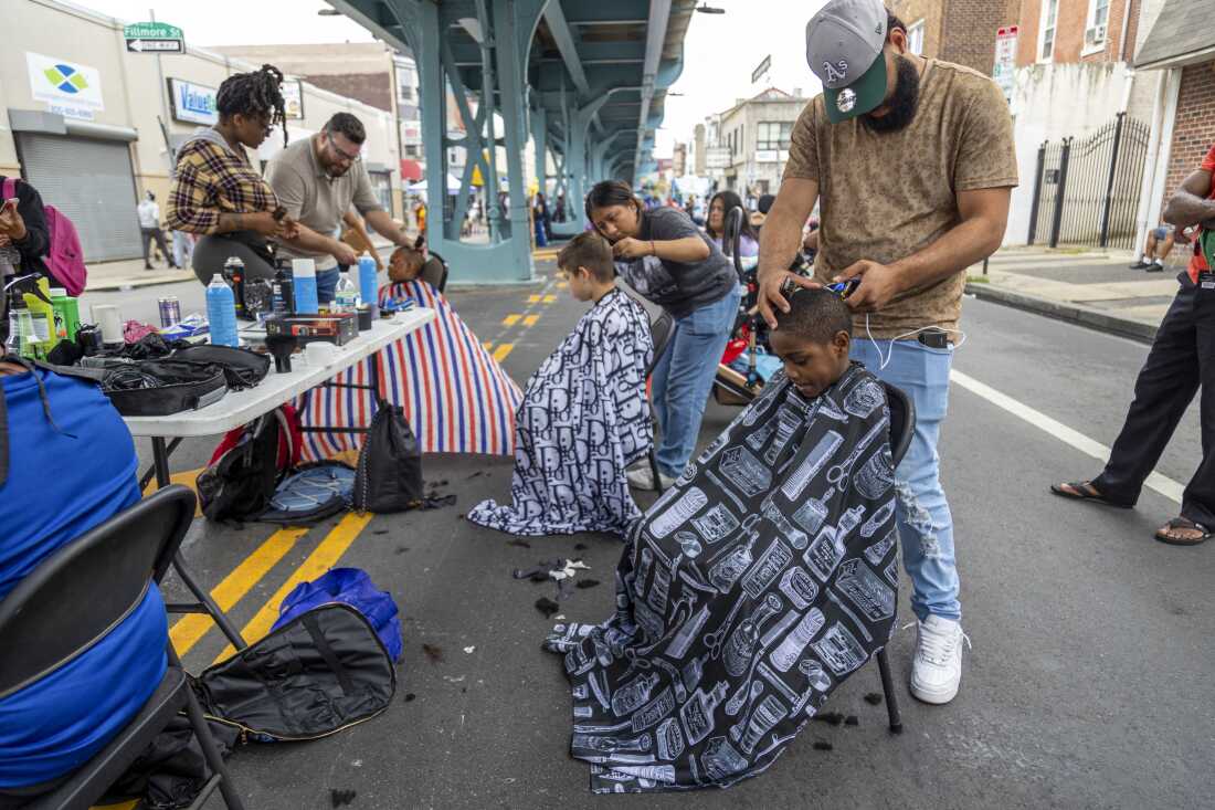 Trainees from the Lehigh Valley Barber and Beauty Academy provide free haircuts as part of a local back-to-school event near Philadelphia's Kensington neighborhood on Aug. 12, 2024.