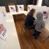 Aliza Bidinger is accompanied by her son Jayce, age 6, as she votes at the 146-year-old Buck Creek school on Election Day, Tuesday, Nov. 5, 2024, in rural Perry, Kan.