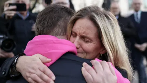 EPA Kim Leadbeater hugs a campaigner for assisted dying 