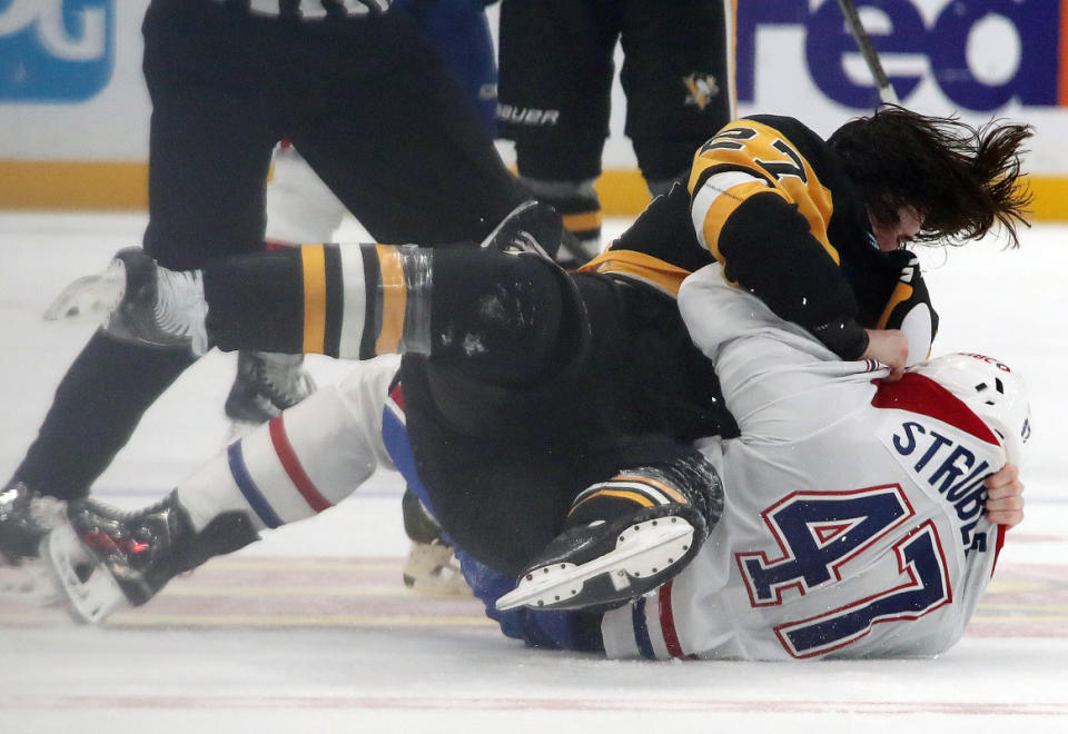 Nov 2, 2024; Pittsburgh, Pennsylvania, USA; Pittsburgh Penguins defenseman Ryan Graves (27) and Montreal Canadiens defenseman Jayden Struble (47) fight as time expires during the third period at PPG Paints Arena. Mandatory Credit: Charles LeClaire-Imagn Images