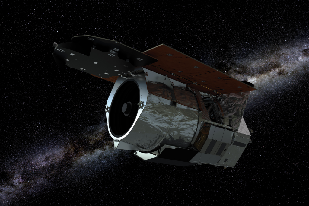 A rendered spacecraft or space telescope with solar panels flying against a star-filled background with the Milky Way visible.