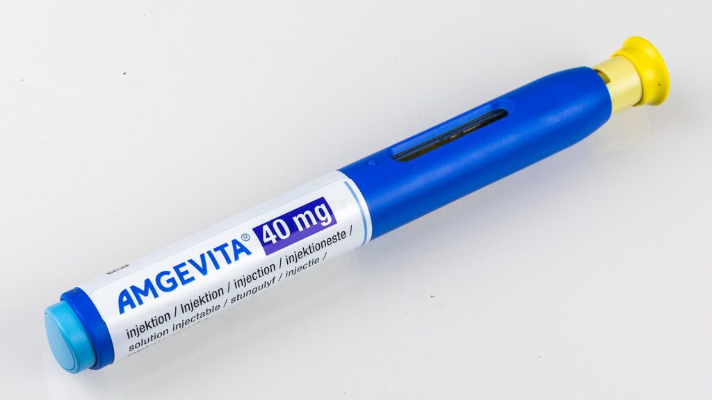 A blue-and-white prefilled injection pen labeled “AMGEVITA 40 mg” on a plain light background.