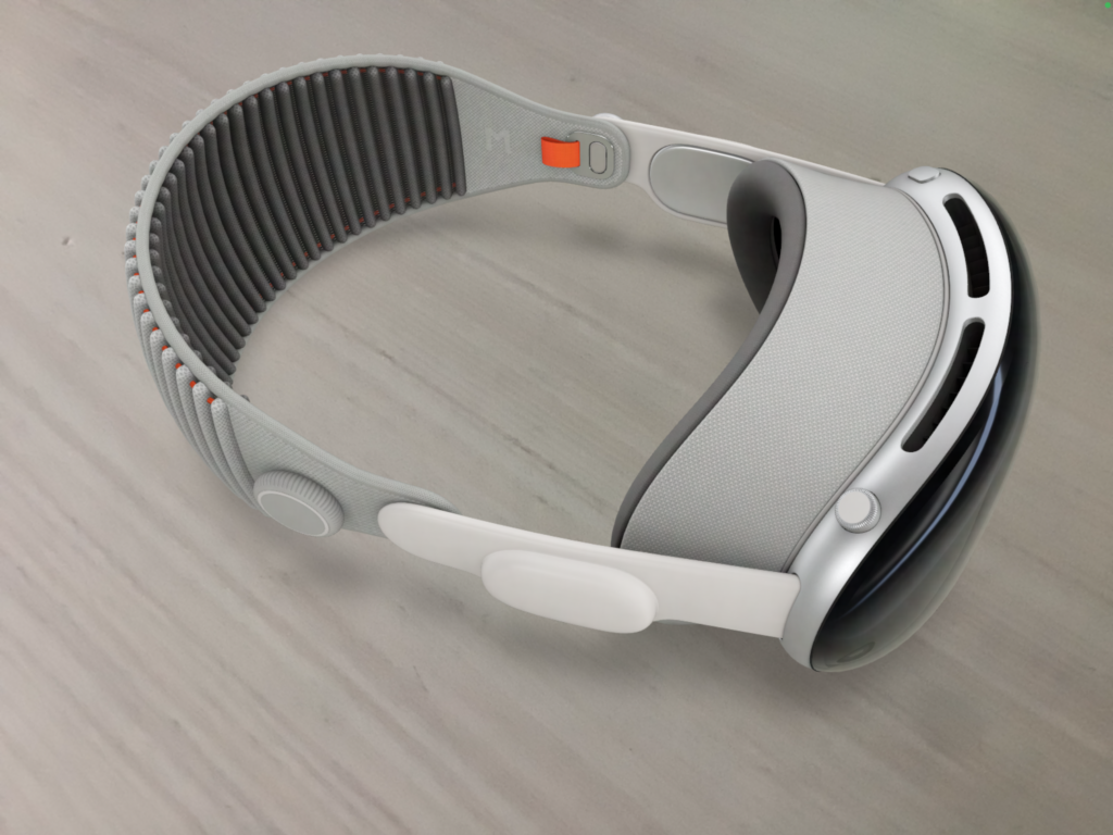 A close view of an Apple Vision Pro headset resting on a light wood surface.