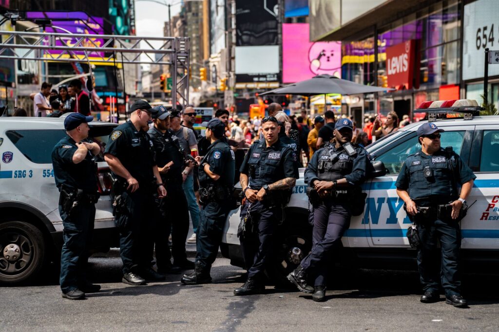 NYPD officers gathered beside police vehicles in Times Square.